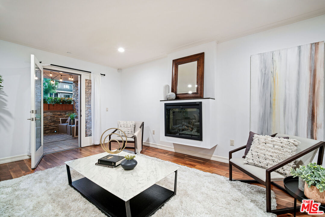 1420 South Bundy Drive, Unit 101 Los Angeles, CA 90025 - Photo 14 of 37 a living room with furniture and a wooden floor
