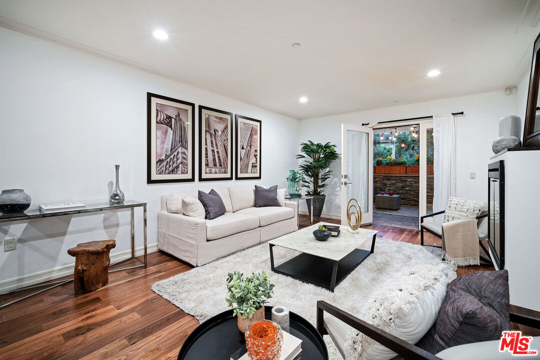 1420 South Bundy Drive, Unit 101 Los Angeles, CA 90025 - Photo 15 of 37 a living room with furniture and wooden floor