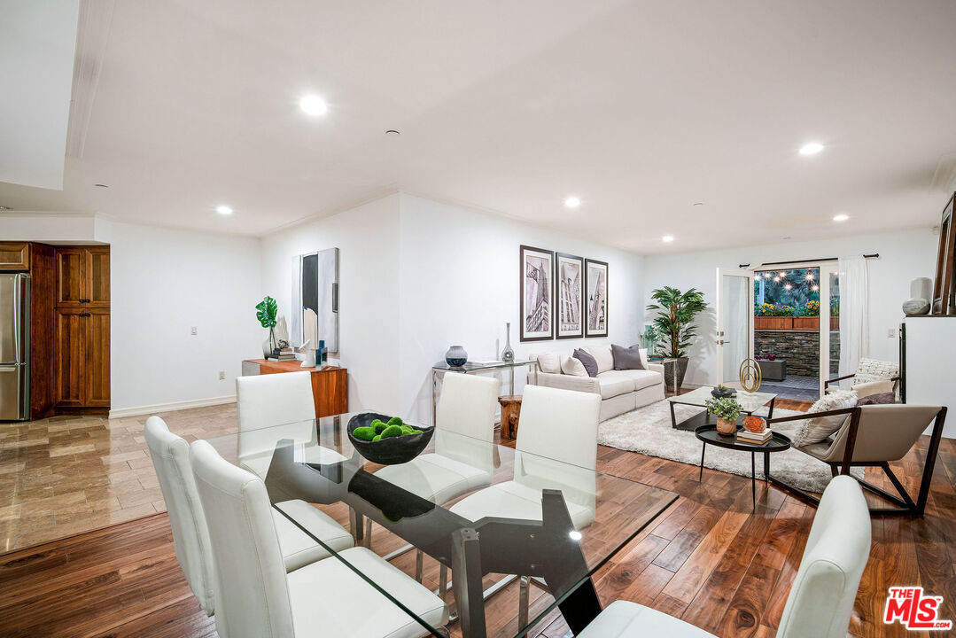1420 South Bundy Drive, Unit 101 Los Angeles, CA 90025 - Photo 19 of 37 a view of a dining room with furniture a rug and wooden floor
