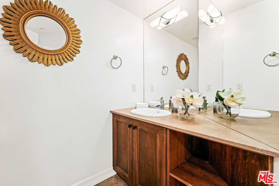 1420 South Bundy Drive, Unit 101 Los Angeles, CA 90025 - Photo 26 of 37 a bathroom with a sink and a mirror