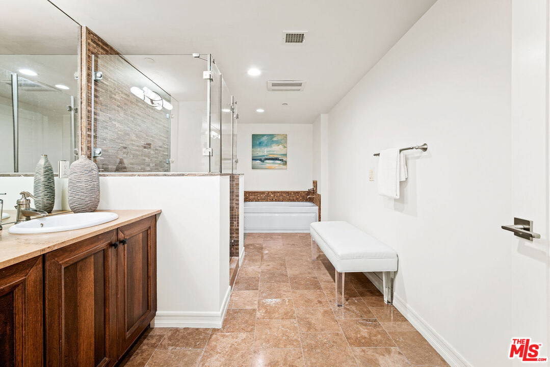 1420 South Bundy Drive, Unit 101 Los Angeles, CA 90025 - Photo 31 of 37 a bathroom with a sink a toilet and shower