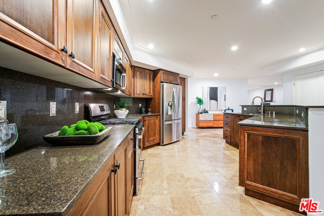 1420 South Bundy Drive, Unit 101 Los Angeles, CA 90025 - Photo 8 of 37 a kitchen with stainless steel appliances granite countertop a stove and a sink