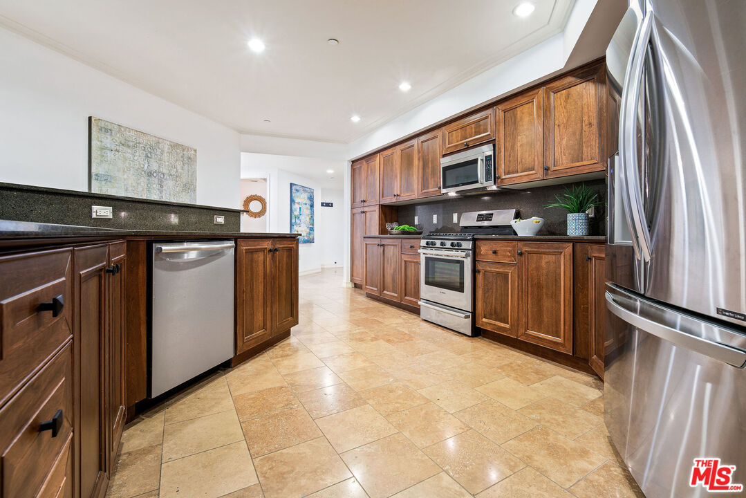 1420 South Bundy Drive, Unit 101 Los Angeles, CA 90025 - Photo 10 of 37 a kitchen with stainless steel appliances granite countertop a refrigerator and a stove