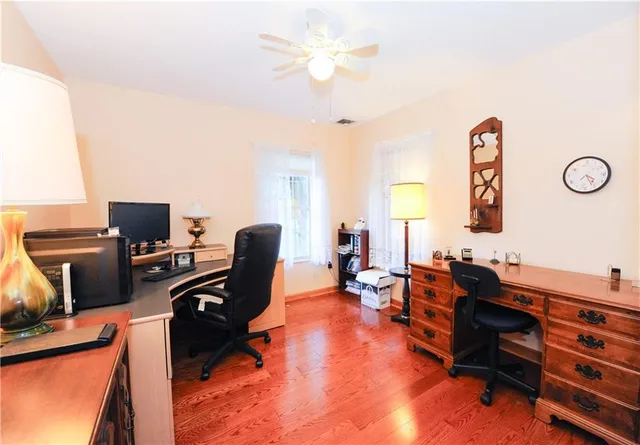 a view of a workspace with furniture and a window