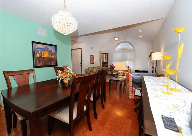 a view of a dining room with furniture and chandelier