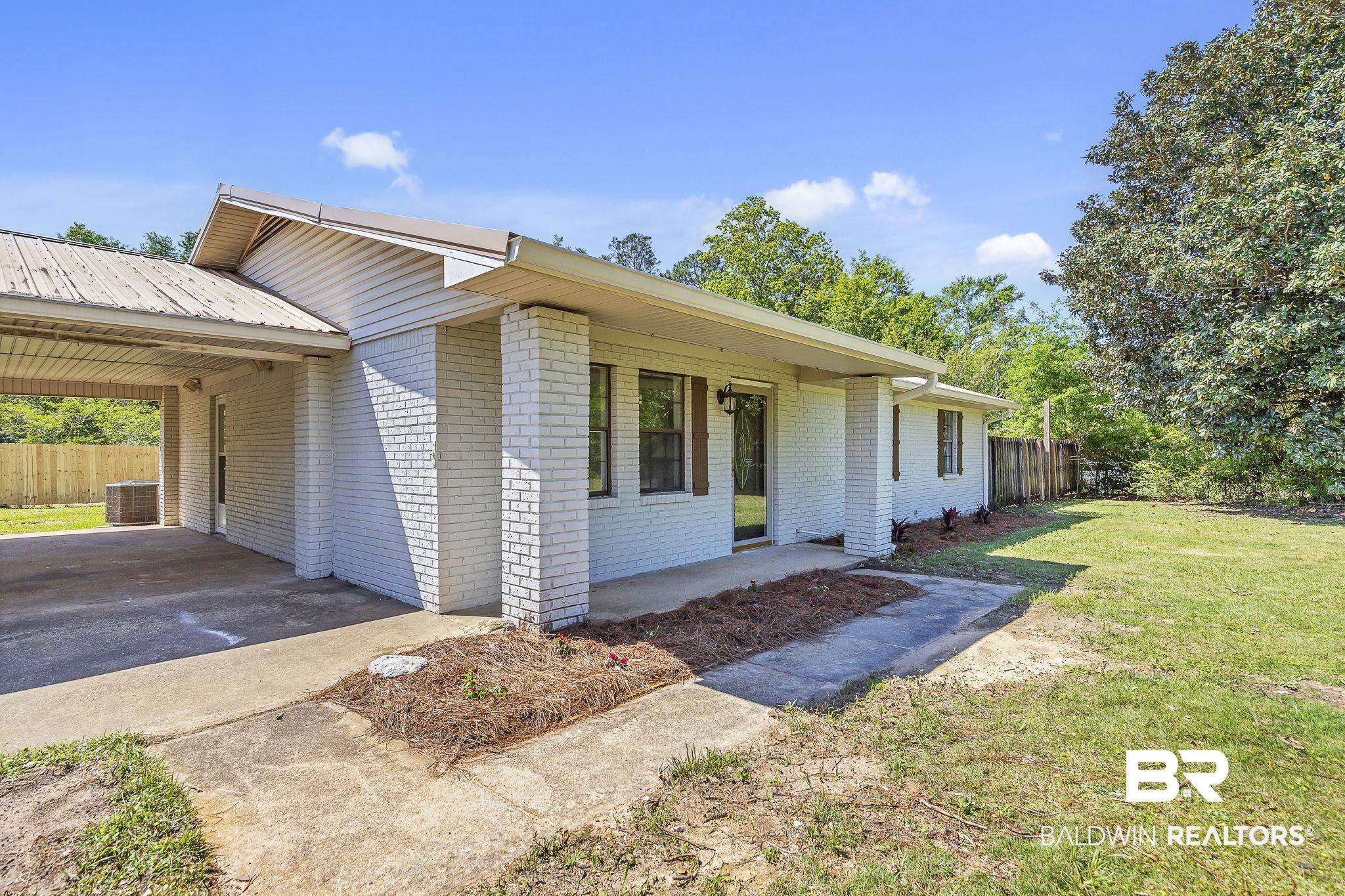 11964 Stroh Road Daphne, AL 36527 - Photo 7 of 58 Single story home with a front yard, driveway, fence, and a carport