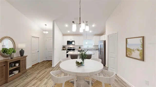 a kitchen with stainless steel appliances granite countertop a sink refrigerator and microwave