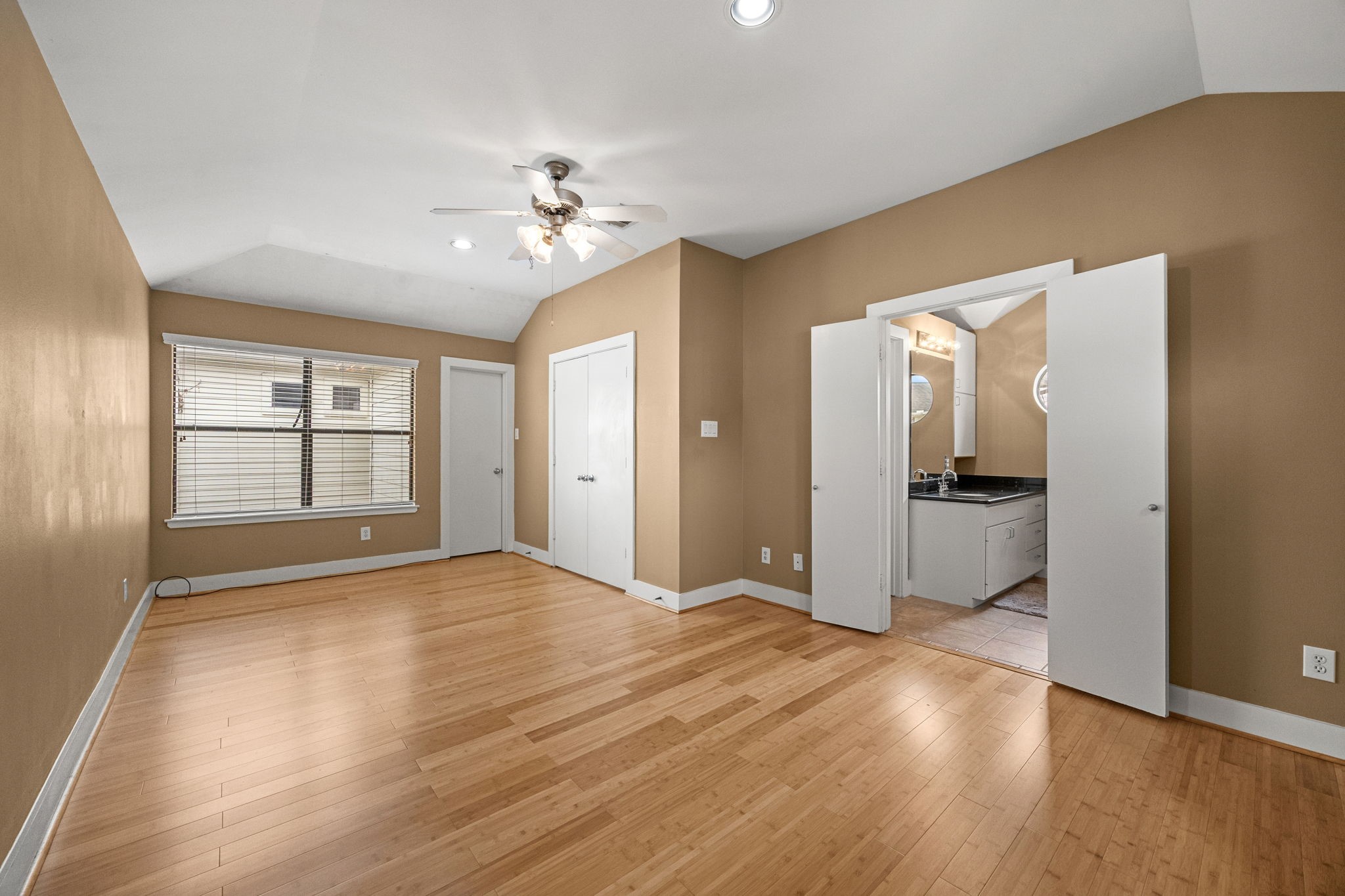 5951 S Loop East, Unit 7 Houston, TX 77033 - Photo 12 of 22 a view of empty room with wooden floor and fan
