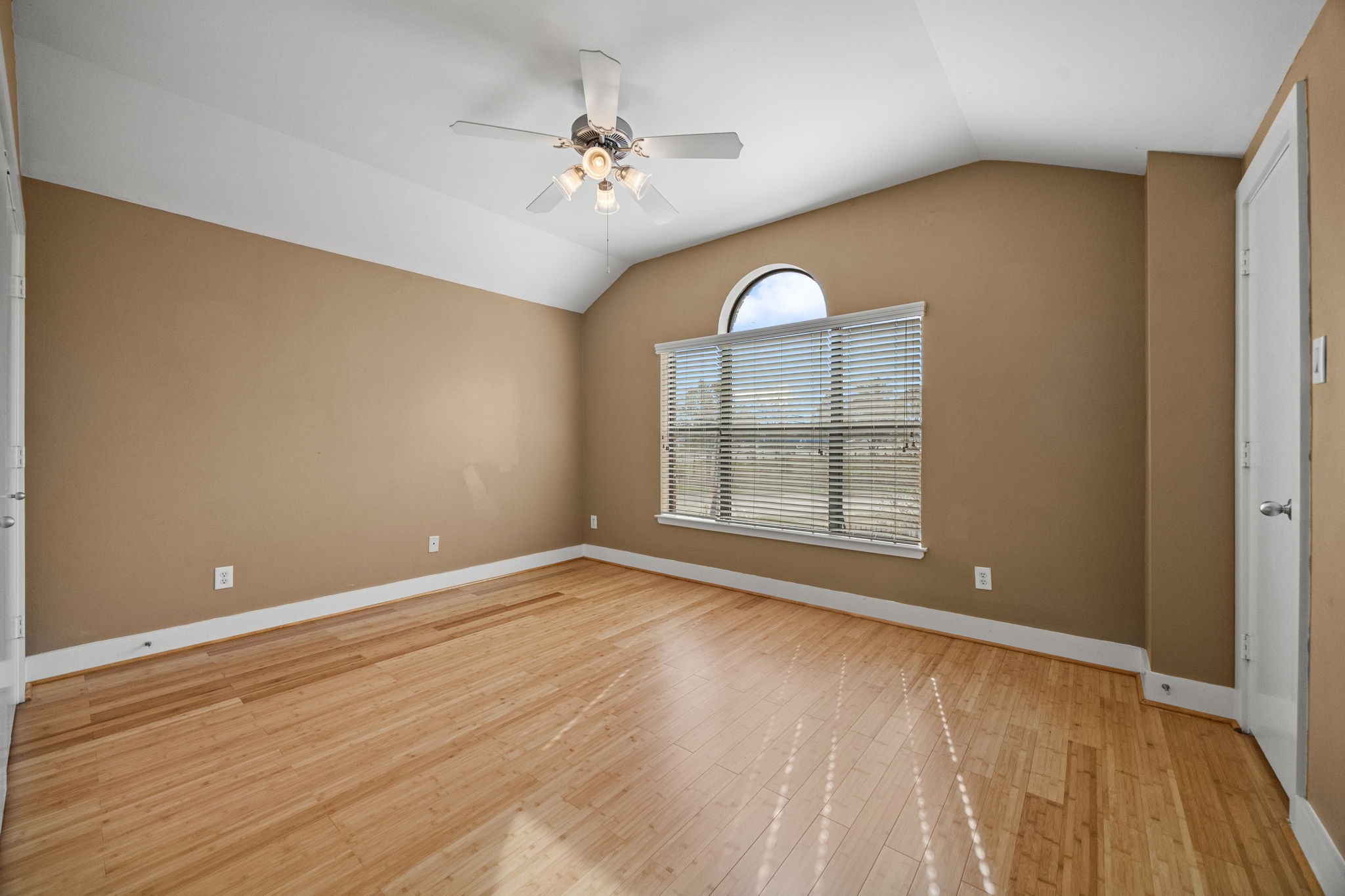 5951 S Loop East, Unit 7 Houston, TX 77033 - Photo 16 of 22 a view of an empty room with a window and wooden floor