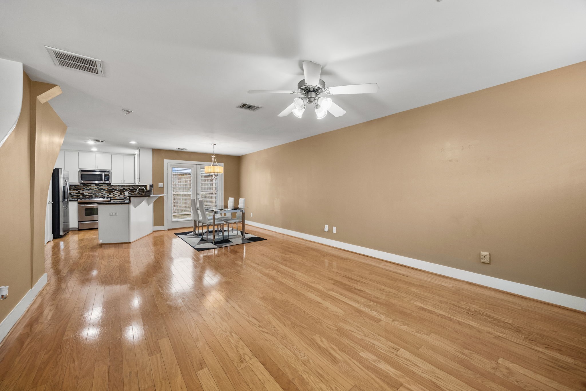 5951 S Loop East, Unit 7 Houston, TX 77033 - Photo 2 of 22 a view of kitchen with furniture and wooden floor