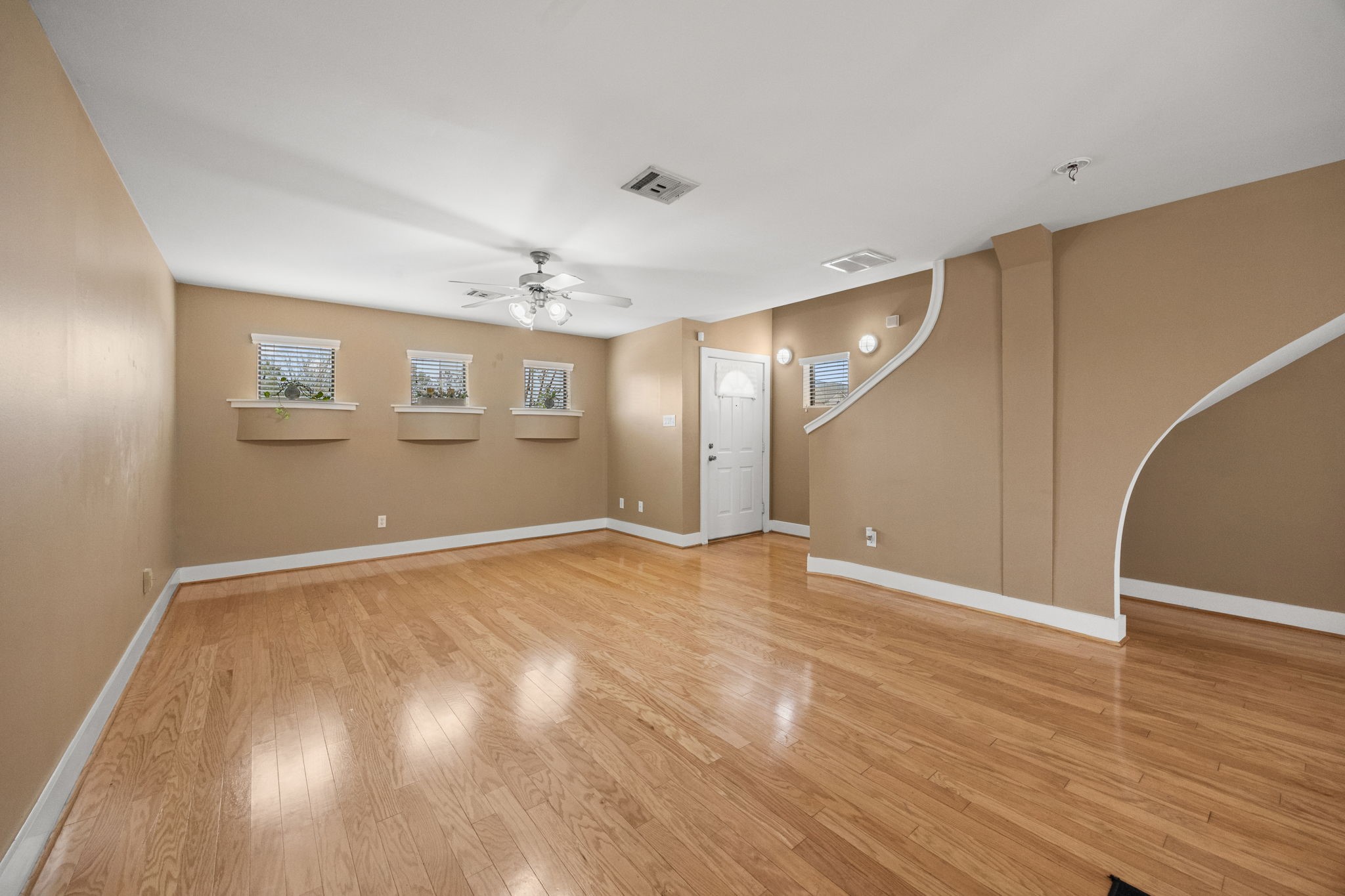 5951 S Loop East, Unit 7 Houston, TX 77033 - Photo 4 of 22 a view of an empty room with wooden floor