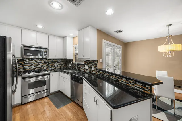 a kitchen that has a sink and a stove