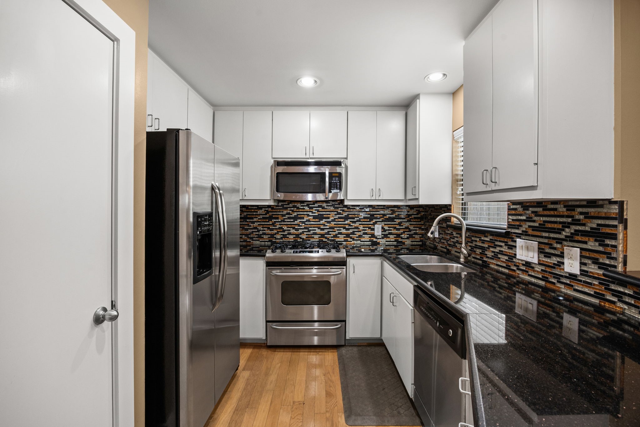 5951 S Loop East, Unit 7 Houston, TX 77033 - Photo 8 of 22 a kitchen with a sink stove and refrigerator