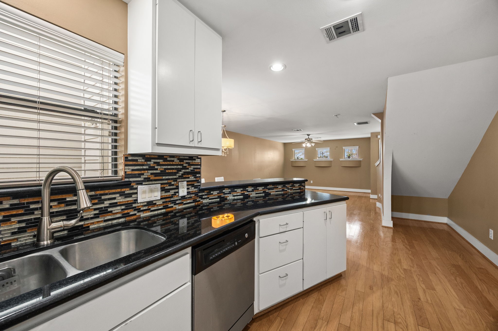 5951 S Loop East, Unit 7 Houston, TX 77033 - Photo 9 of 22 a kitchen with granite countertop a sink a stove and cabinets