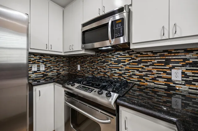 a close view of a stove a microwave and cabinets