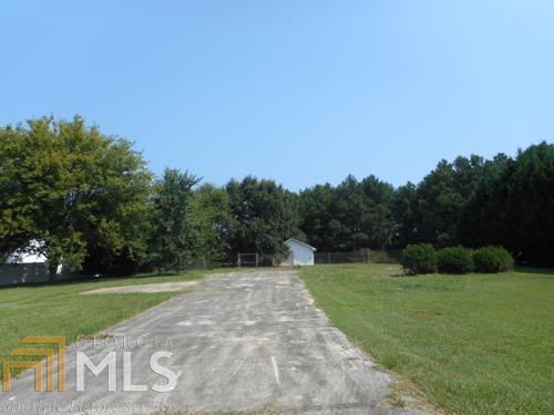 164 E-Rd Ls 7 Cochran, GA 31014 - Photo 1 of 1 a view of a grassy field with trees in the background