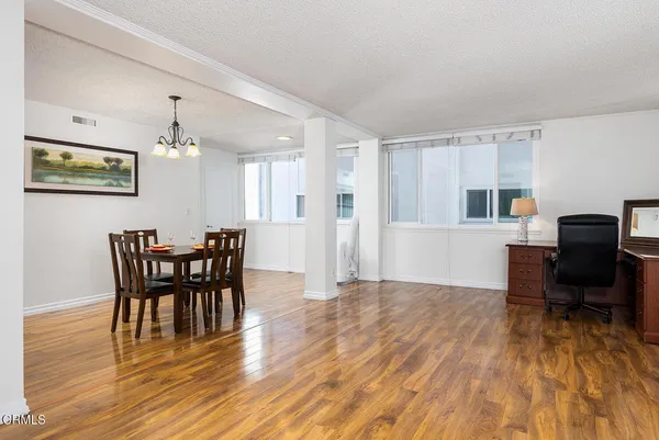 a view of a dining room with furniture and wooden floor