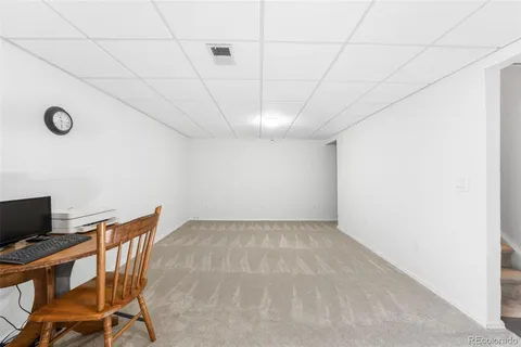 a view of a workspace with furniture