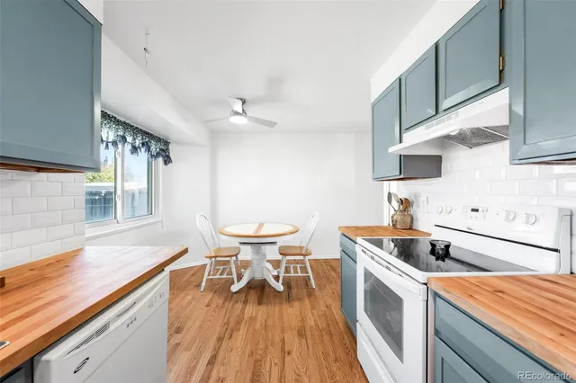 a kitchen with a sink and wooden floor