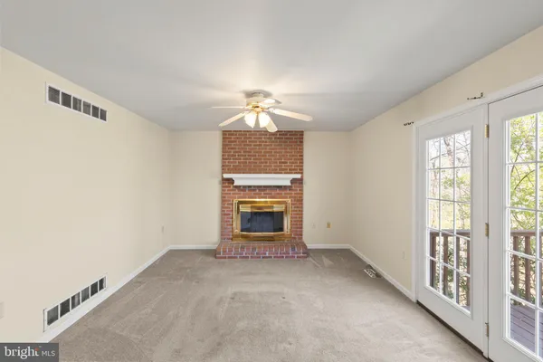 an empty room with a ceiling fan and a window