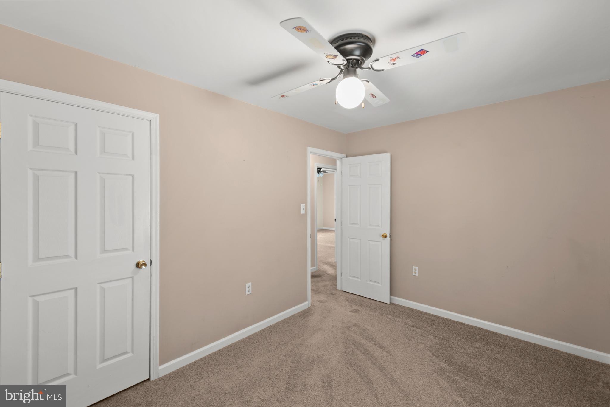 430 Babbs Mountain Road Winchester, VA 22603 - Photo 33 of 49 an empty room with a chandelier fan and a ceiling fan