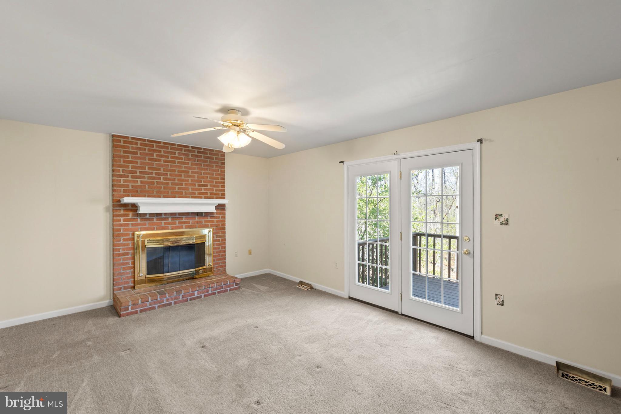 430 Babbs Mountain Road Winchester, VA 22603 - Photo 7 of 49 a view of an empty room with a fireplace and a window