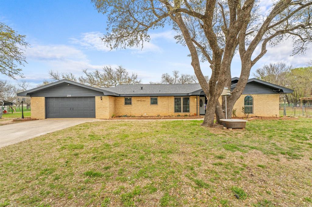 211 Bluebonnet Drive Early, TX 76802 - Photo 1 of 1 a front view of a house with a garden