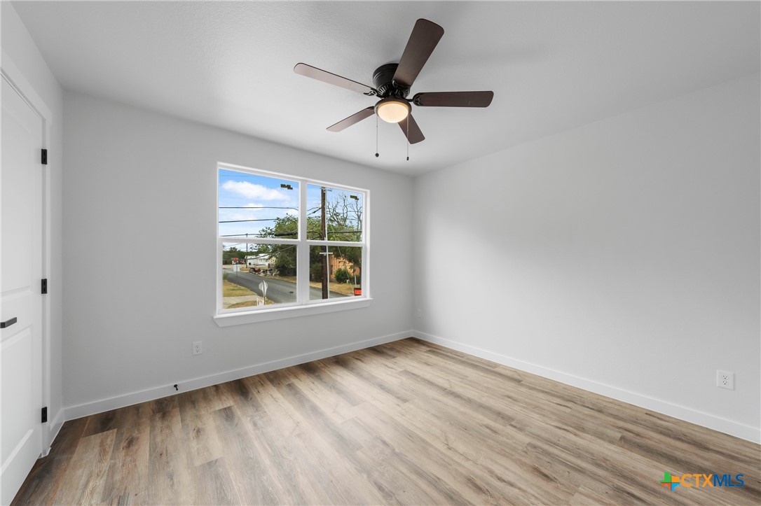 712 South 28th Street, Unit B Temple, TX 76501 - Photo 14 of 24 a view of an empty room with wooden floor and a window