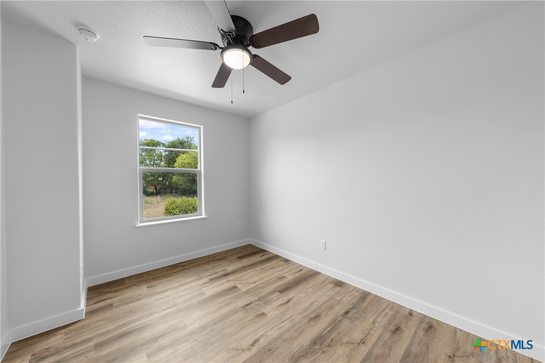 712 South 28th Street, Unit B Temple, TX 76501 - Photo 18 of 24 an empty room with a window and ceiling fan