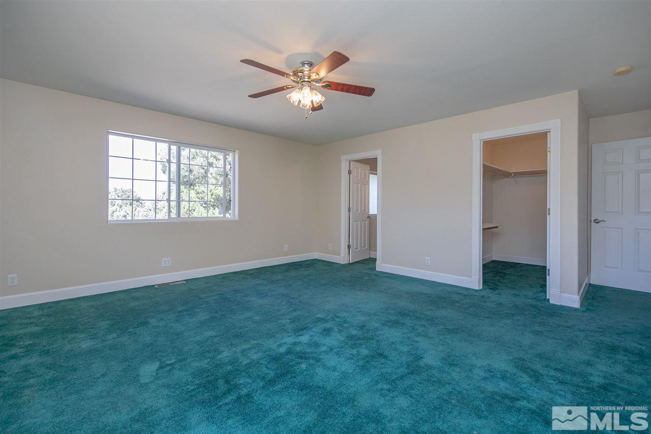 21859 Adobe Road Reno, NV 89521 - Photo 17 of 40 a view of an empty room with window and chandelier fan