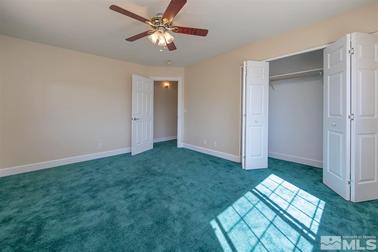 21859 Adobe Road Reno, NV 89521 - Photo 23 of 40 a view of empty room with floor to ceiling window and ceiling fan