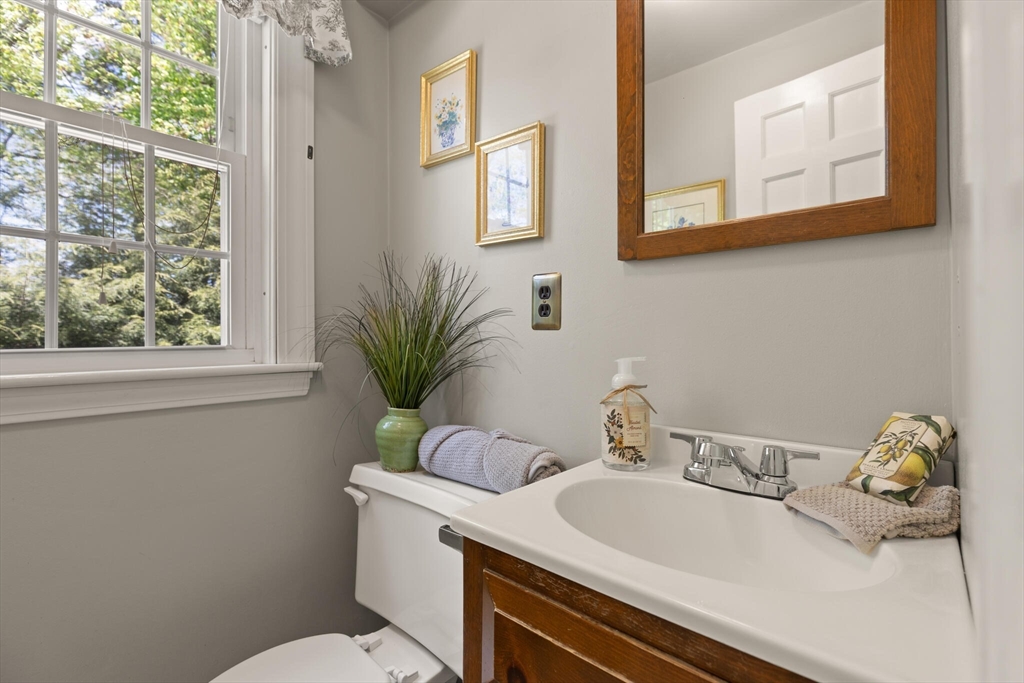51 Pine Ridge Road Reading, MA 01867 - Photo 19 of 30 a bathroom with a toilet a sink and mirror