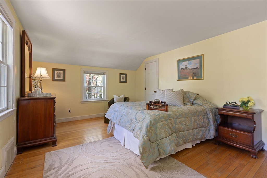 51 Pine Ridge Road Reading, MA 01867 - Photo 23 of 30 a bedroom with a bed and wooden floor