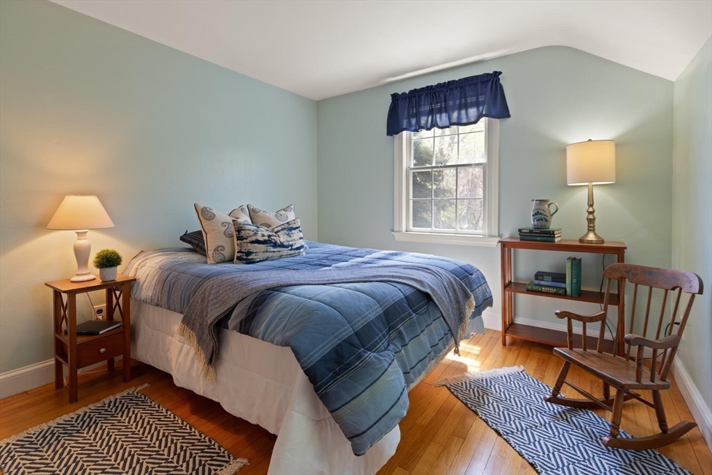 51 Pine Ridge Road Reading, MA 01867 - Photo 25 of 30 a bedroom with a bed wooden floor and lamp