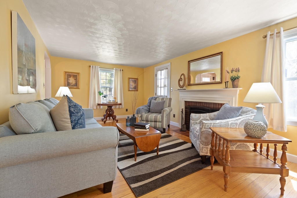 51 Pine Ridge Road Reading, MA 01867 - Photo 10 of 30 a living room with furniture and a fireplace