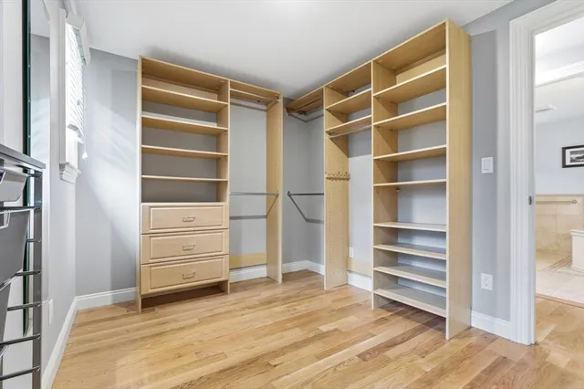 a view of walk in closet with empty racks