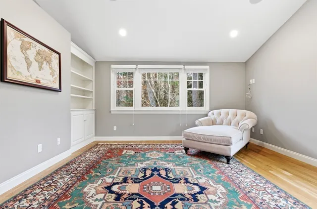 a bedroom with furniture and a rug