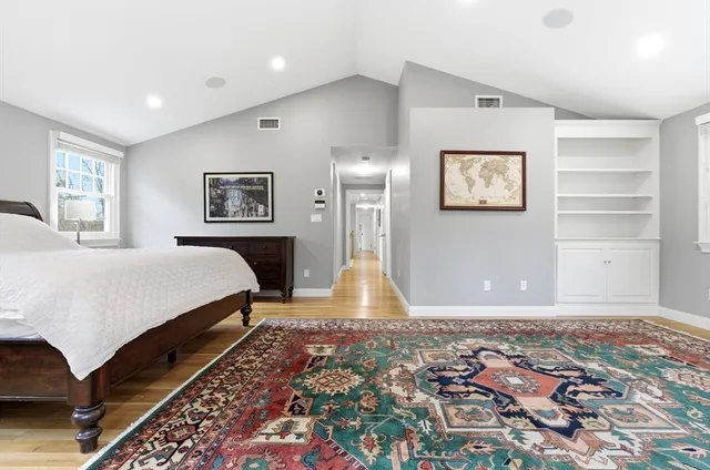 a bedroom with a bed and a painting on the wall