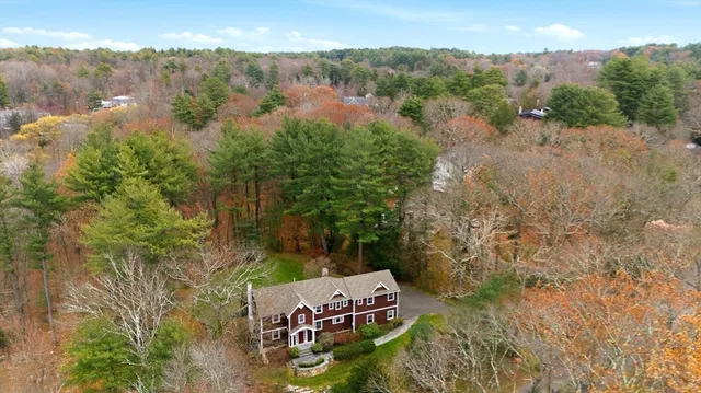 an aerial view of a house with a yard