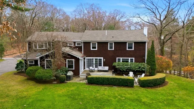 a front view of house with yard and green space