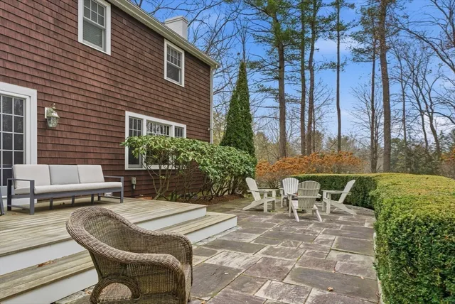 a view of a patio with couches table and chairs and potted plants