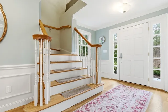 a view of entryway with wooden floor and a rug