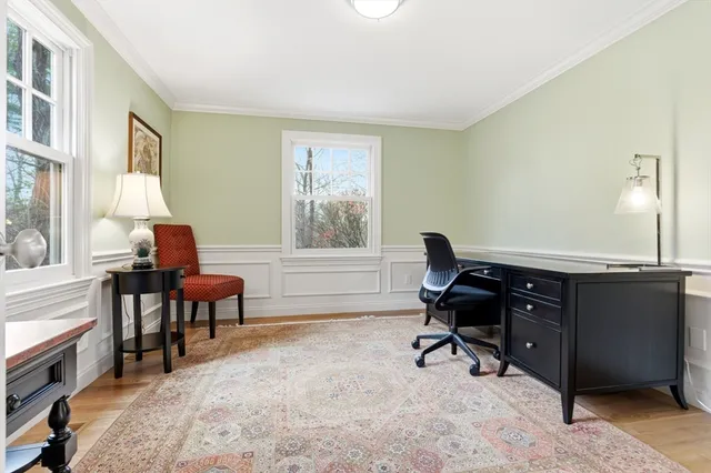 a view of a workspace with furniture and a window