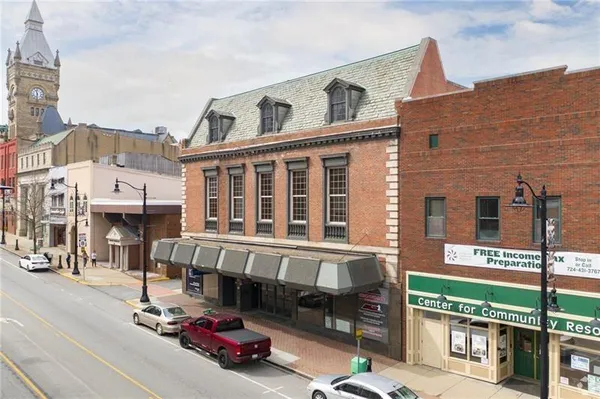 a front view of a building with parking area