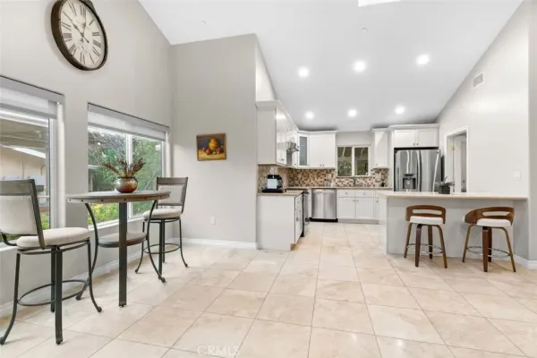 a kitchen with a table and chairs