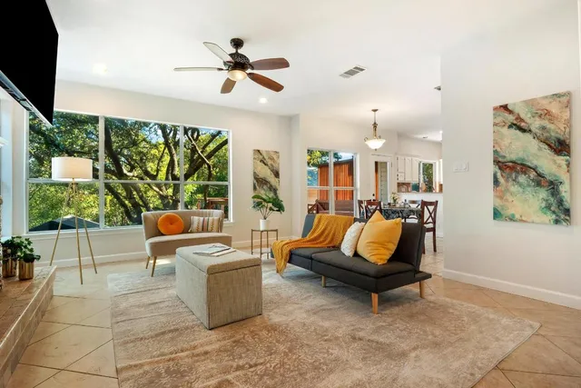a living room with patio furniture and a flat screen tv