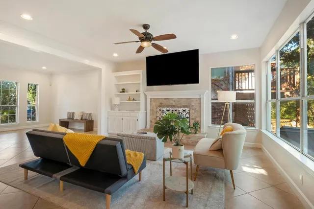 a living room with furniture fireplace and a flat screen tv