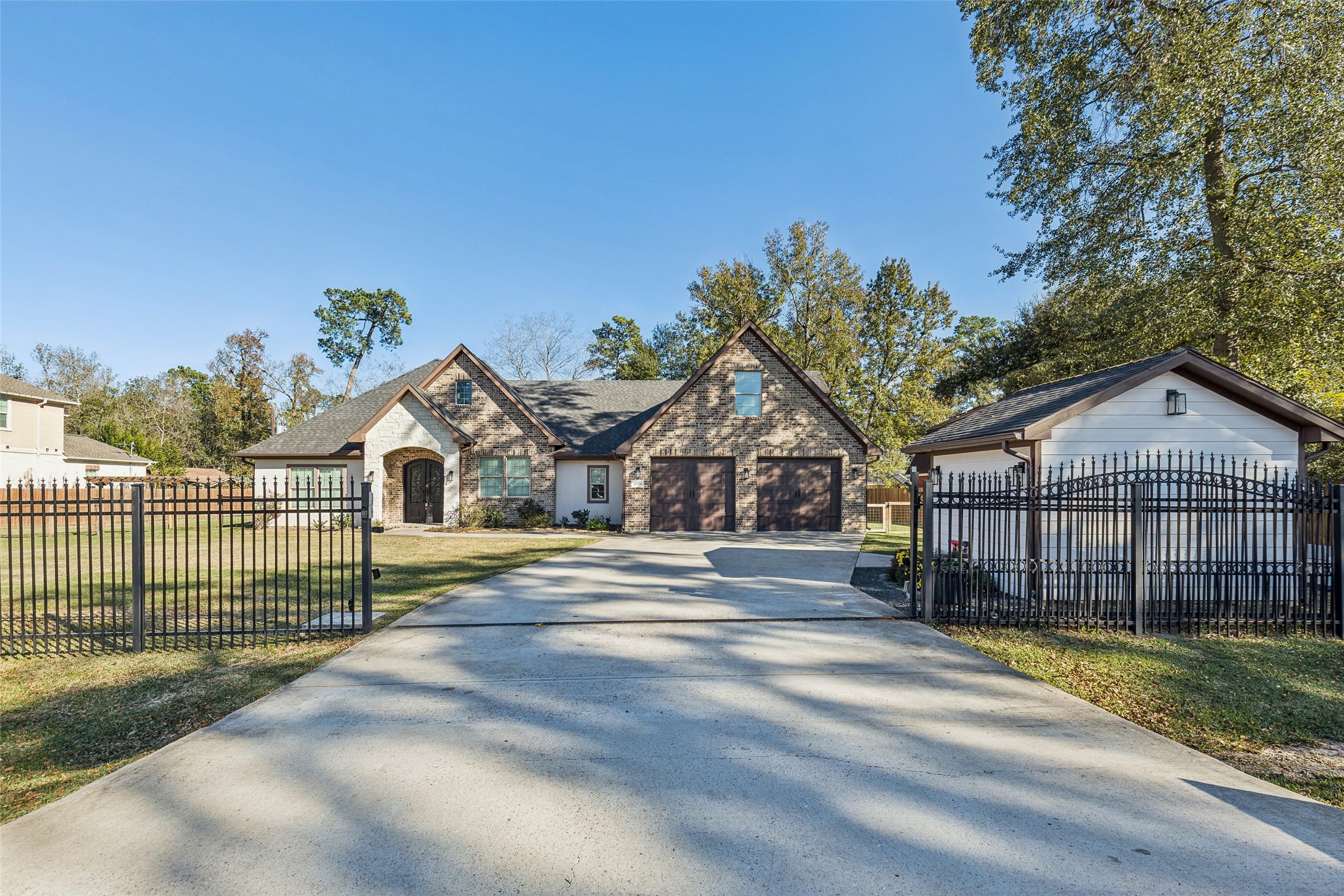 a view of a large house with a big yard and large trees
