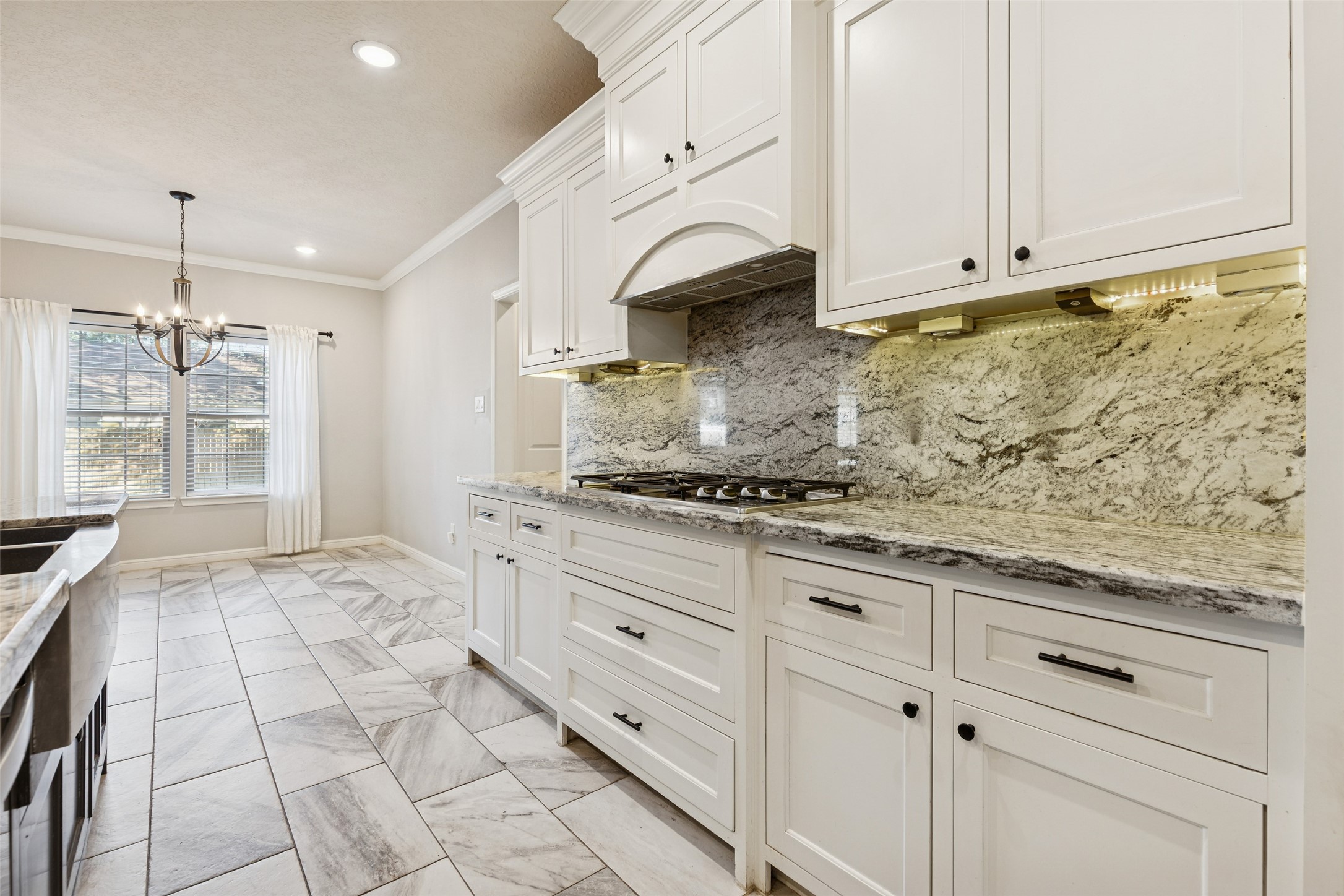 21724 Stargrass Drive Spring, TX 77388 - Photo 15 of 50 a kitchen with granite countertop white cabinets and stainless steel appliances
