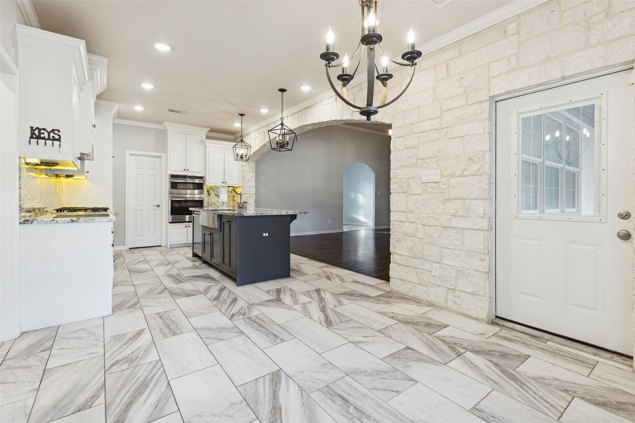 21724 Stargrass Drive Spring, TX 77388 - Photo 16 of 50 a kitchen with stainless steel appliances kitchen island granite countertop a refrigerator and a stove top oven